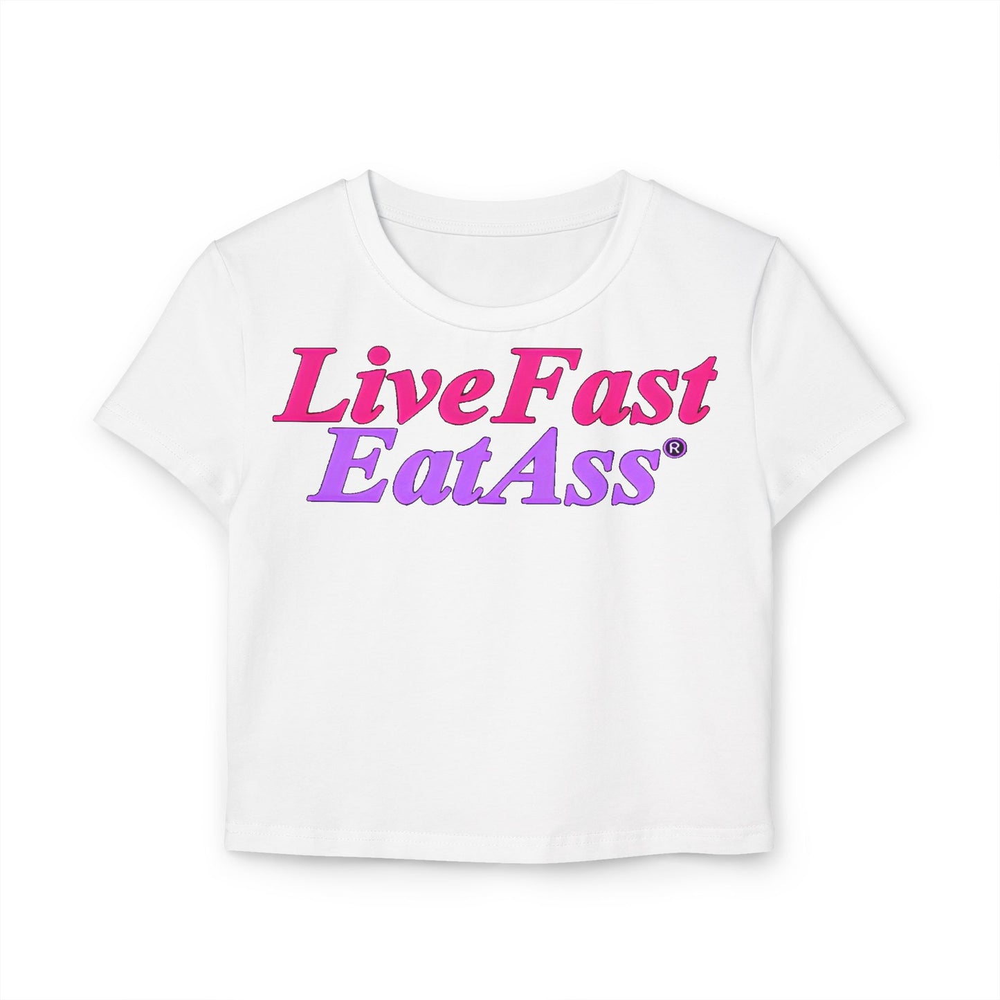 Chic women's cropped t-shirt in white featuring vibrant 'Live Fast EatAss' text in hot pink and purple gradient, embodying playful elegance.