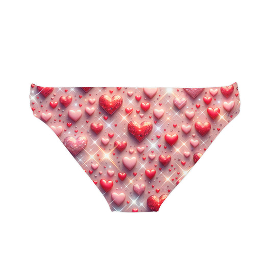 Glittering Hearts Loop Tie Side Bikini Bottom showcasing a chic pastel pink pattern embellished with shimmering hearts, ideal for stylish beach outings.