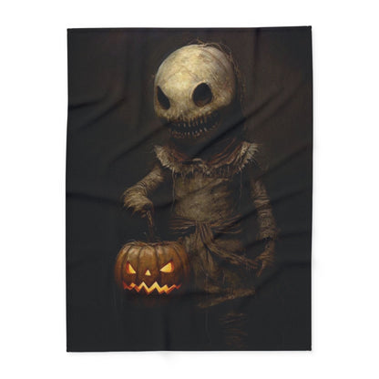 Chic Decorative and Warm Halloween Spooky Arctic Fleece Blanket depicting an eerie figure with a glowing pumpkin, a sophisticated addition to Halloween ambiance.