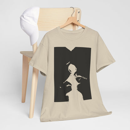 Chic unisex graphic t-shirt artfully arranged with a white cap on a wooden chair, showcasing a provocative black and white design for a trendy outfit.