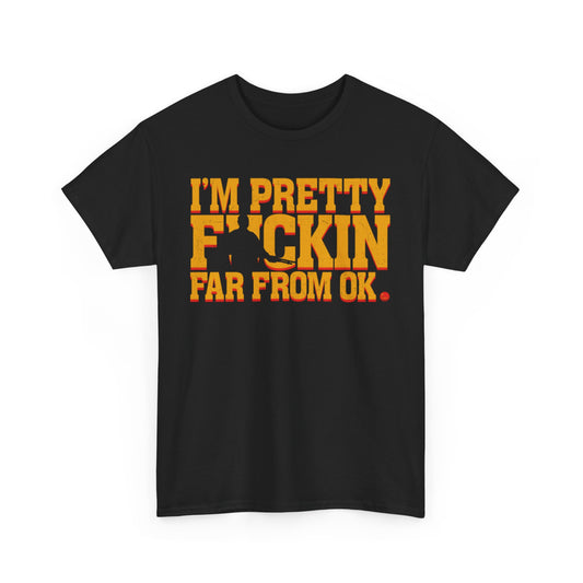 Chic black t-shirt showcasing the striking phrase 'I'M PRETTY FICKIN FAR FROM OK.' in vibrant yellow and orange tones, offering a perfect blend of humour and style for unisex wear.