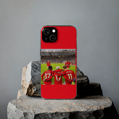 Sophisticated Manchester United Mainoo Garnach Hojlund Soft Phone Case resting on textured stones, illustrating its luxurious appeal and team loyalty for avid soccer fans.
