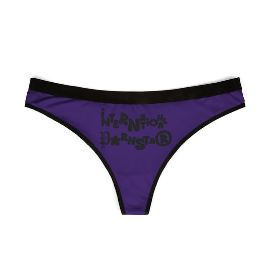 Stylish purple thong with black trim, displaying the cheeky 'International Star' logo in a fun font, designed for playful yet sophisticated lingerie collections.