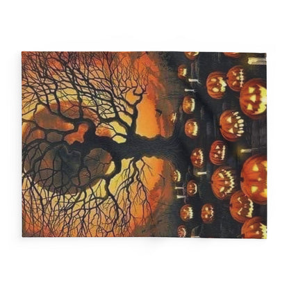 Decorative and Warm Halloween Spooky Arctic Fleece Blanket presenting an enchanting view of eerie pumpkins and a shadowy tree illuminated by a fading sunset.