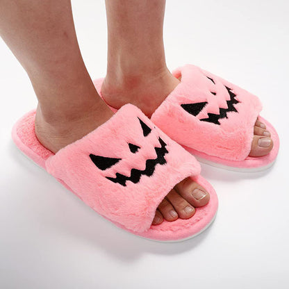 Halloween Shoes Winter Cute Warm Home Slippers for women in soft pink fur, showcasing a charming pumpkin face, perfect for adding warmth and style to your winter home attire.