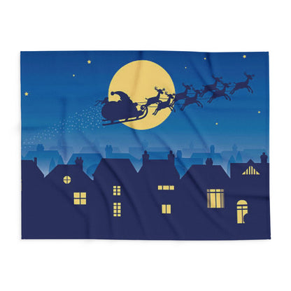 Decorative and Warm Christmas Arctic Fleece Blanket displayed in a vibrant blue hue, illustrating a whimsical night-time winter theme with Santa and reindeer.