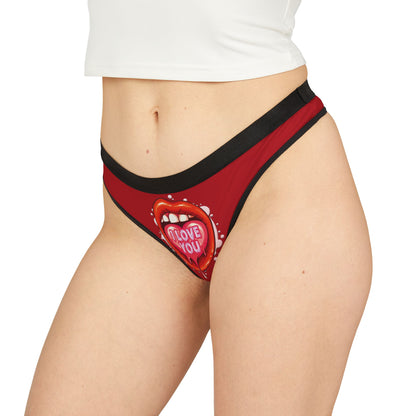 Model showcasing a cheeky red thong with a bold graphic design, ideal for romantic occasions and special celebrations.
