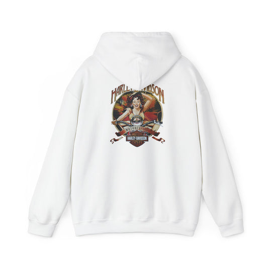 Harley-Davidson vintage pin-up hoodie showcasing a vibrant back print featuring a spirited woman on a classic motorcycle, elegantly blending soft beige and sunset hues.