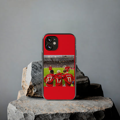 Elegant Manchester United Mainoo Garnach Hojlund Soft Phone Case resting on sophisticated stones, featuring an exquisite image of team camaraderie and vivid colours, perfect for football lovers.