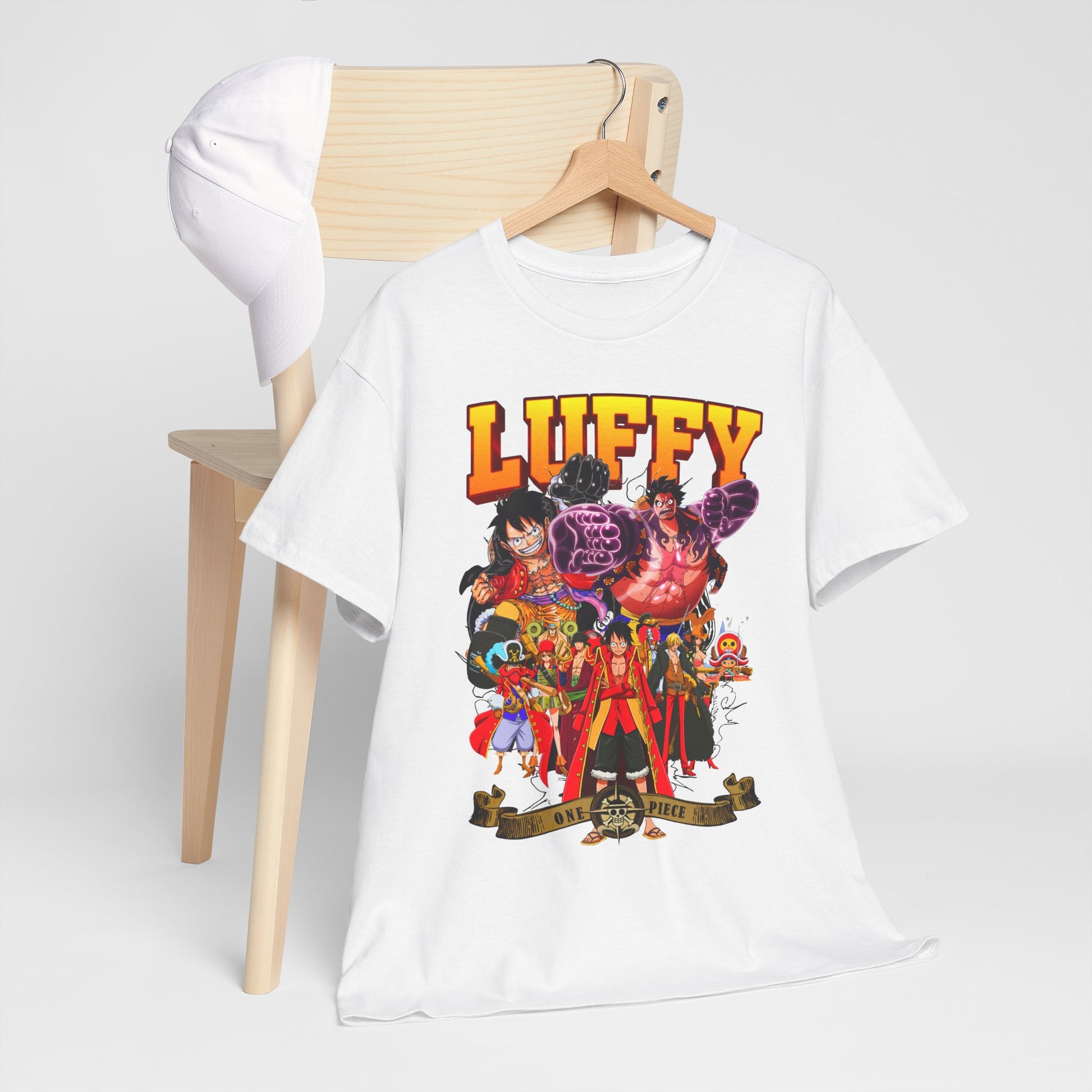 Chic white t-shirt featuring stunning artwork of Luffy and One Piece characters, styled with a baseball cap on a minimalist chair, perfect for refined fashion lovers.