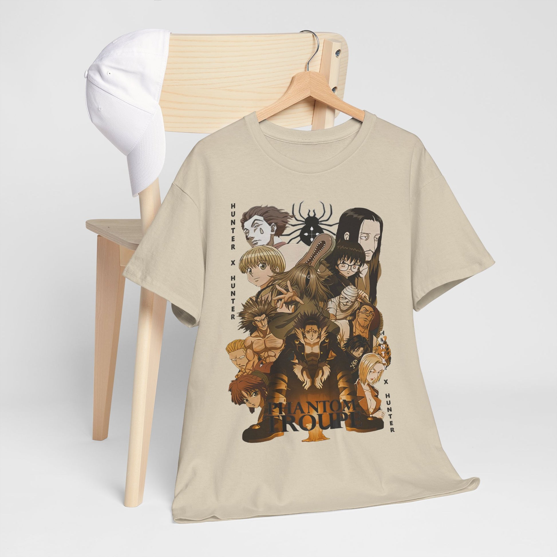 Stylish Phantom Troupe Hunter x Hunter graphic t-shirt showcased alongside a classy white cap on a wooden chair, demonstrating a sophisticated casual look.