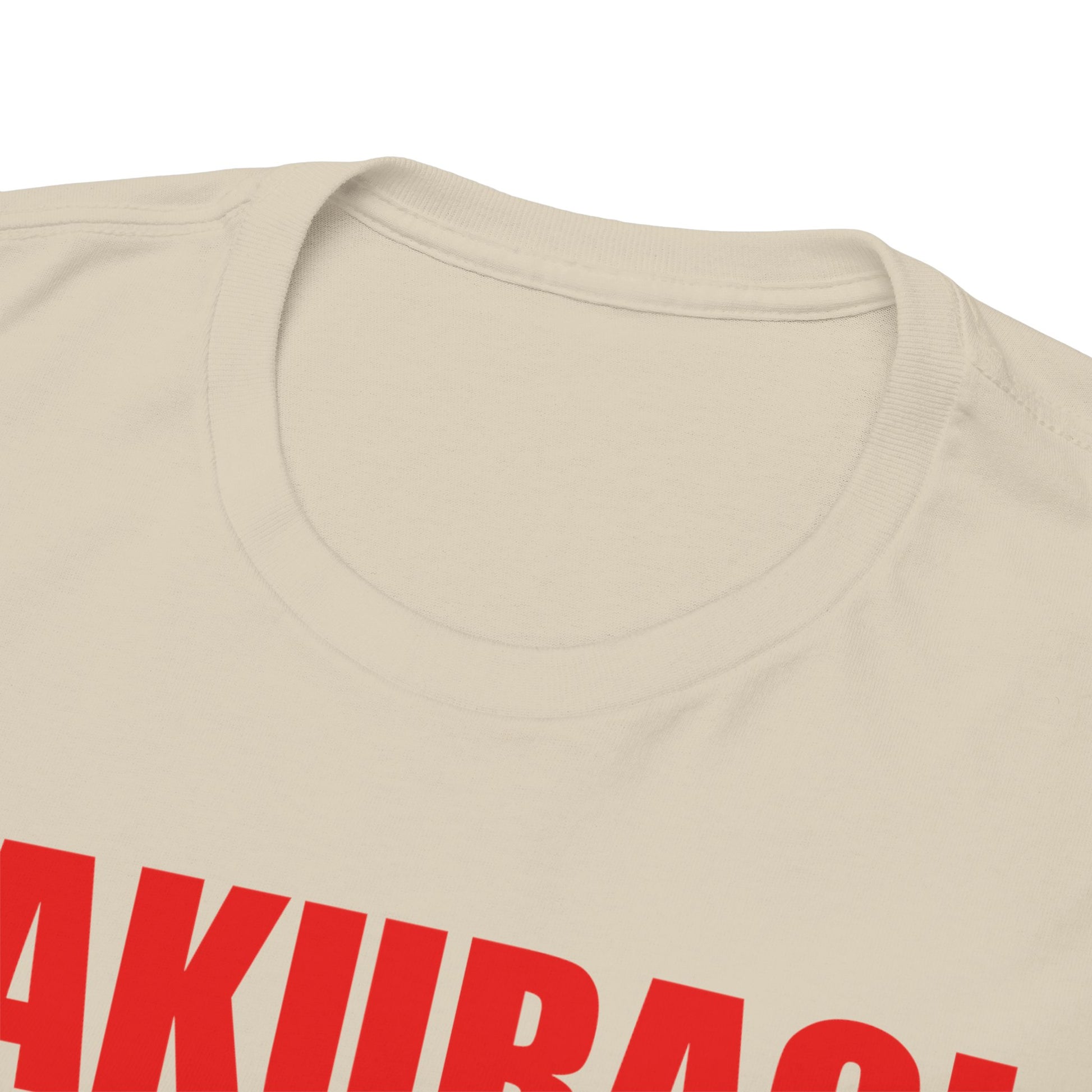 Close-up view of the neckline of the upscale beige t-shirt showcasing the striking 'SAKURAGI' print in vibrant red, emphasizing the quality craftsmanship and style.