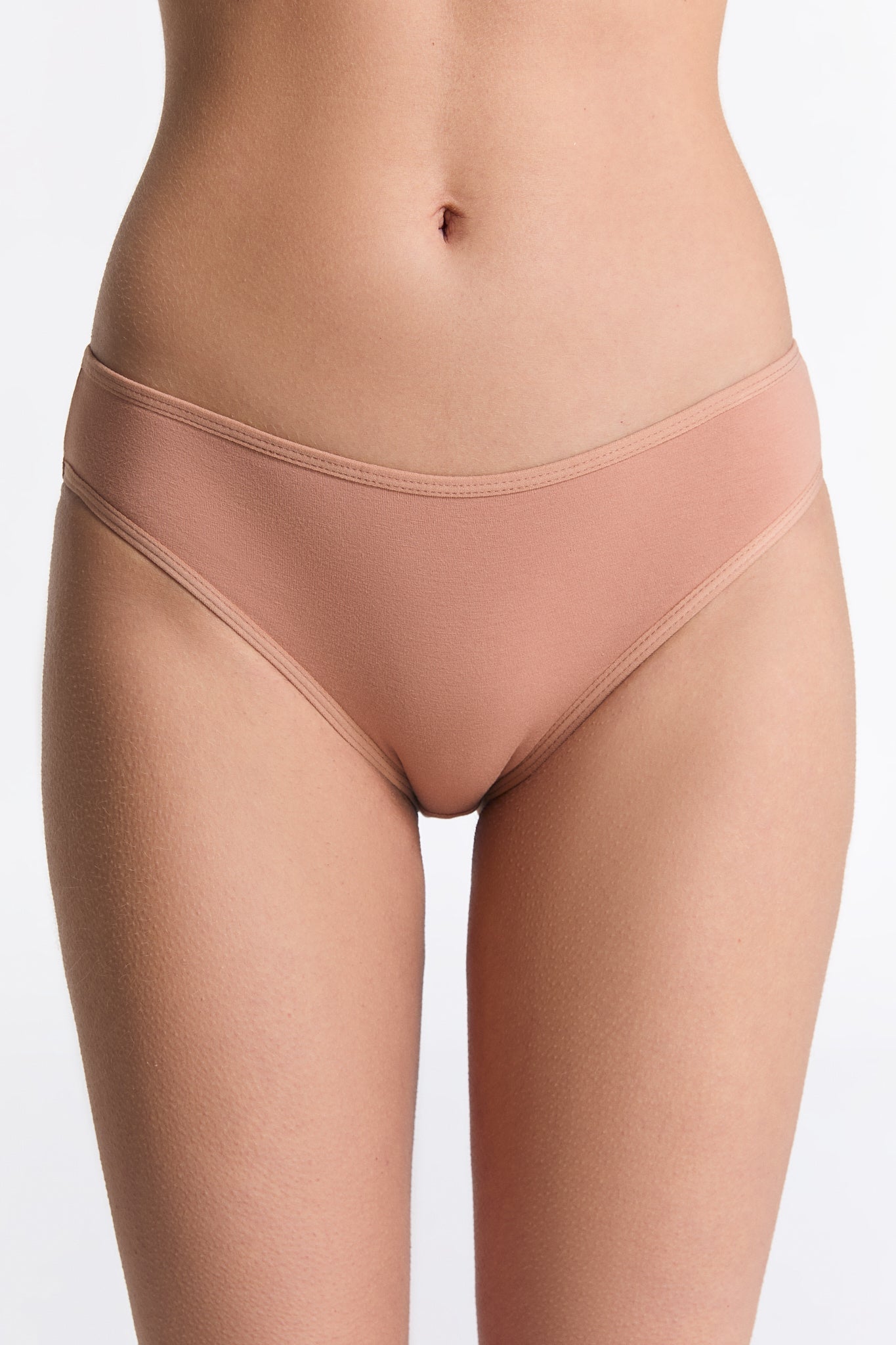Beautifully arranged women's organic cotton briefs in assorted sizes, emphasizing luxury and sustainability in fashion.