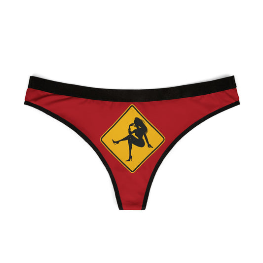 Stylish women's thong in rich red with a striking yellow caution sign graphic, embodying a humorous and flirty touch ideal for special celebrations.