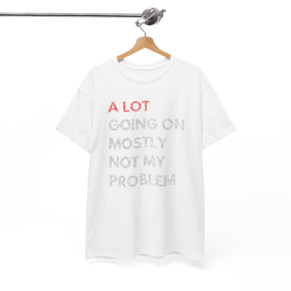 Chic white t-shirt elegantly hanging, featuring the humorous text 'A LOT GOING ON MOSTLY NOT MY PROBLEM' in bold red and understated gray, a perfect addition to any stylish ensemble.