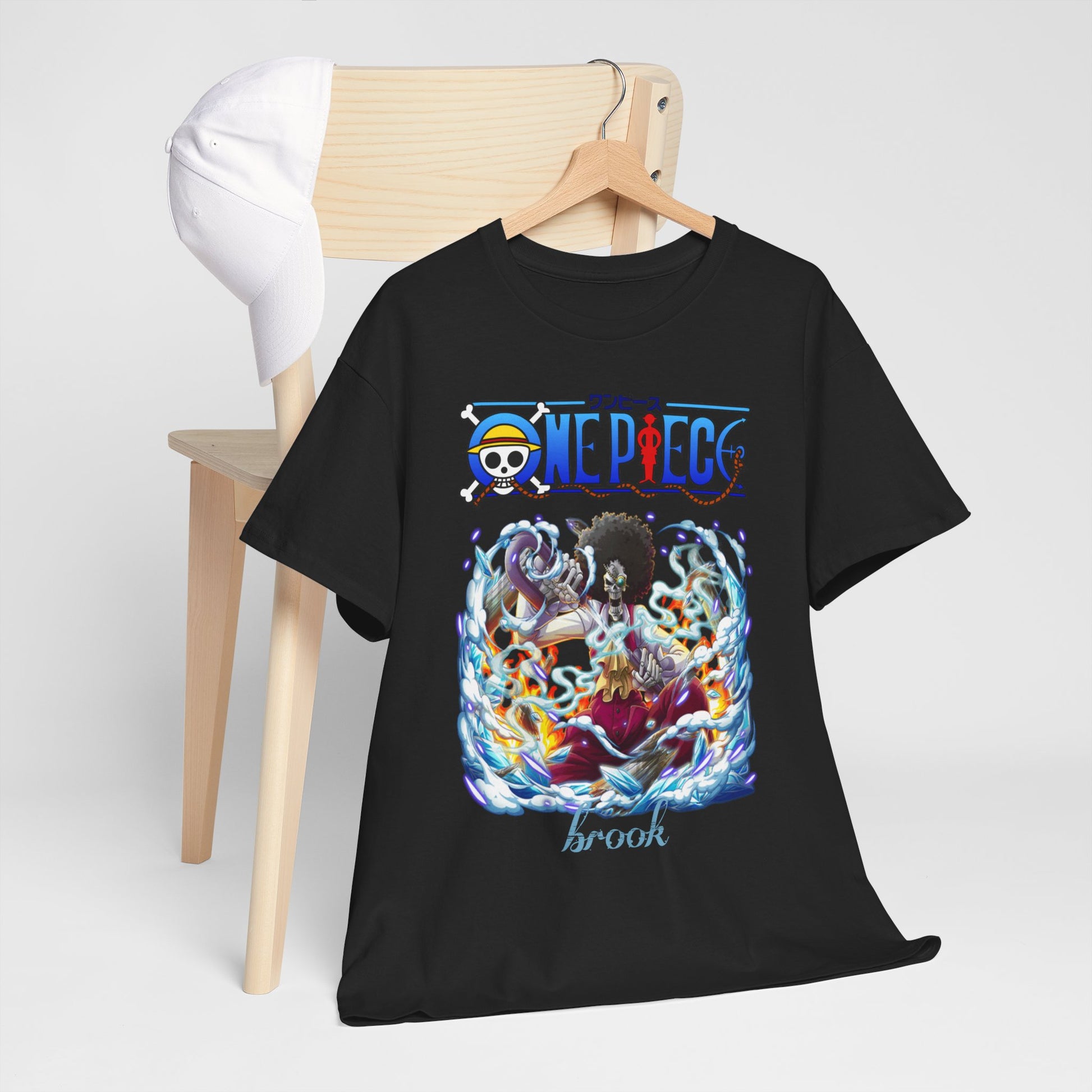 Stylish black men's t-shirt featuring an intricate design of Brook from One Piece, elegantly displayed on a wooden hanger, with a fashionable cap nearby, highlighting its trendy appeal.