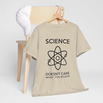 Stylish beige men's t-shirt featuring bold black 'SCIENCE' text and an atom graphic, elegantly displayed against a minimalist backdrop with a wooden chair and white cap.