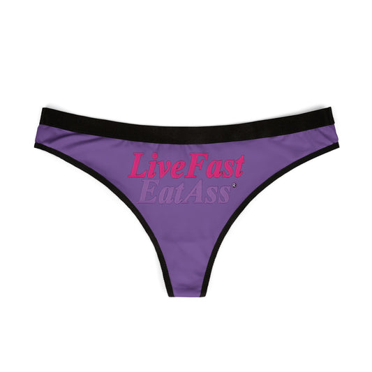 Designer cheeky thong panties in purple with a prominent 'Live Fast Eat Ass' print, elegantly displayed flat to emphasize the high-quality fabric and playful typography.
