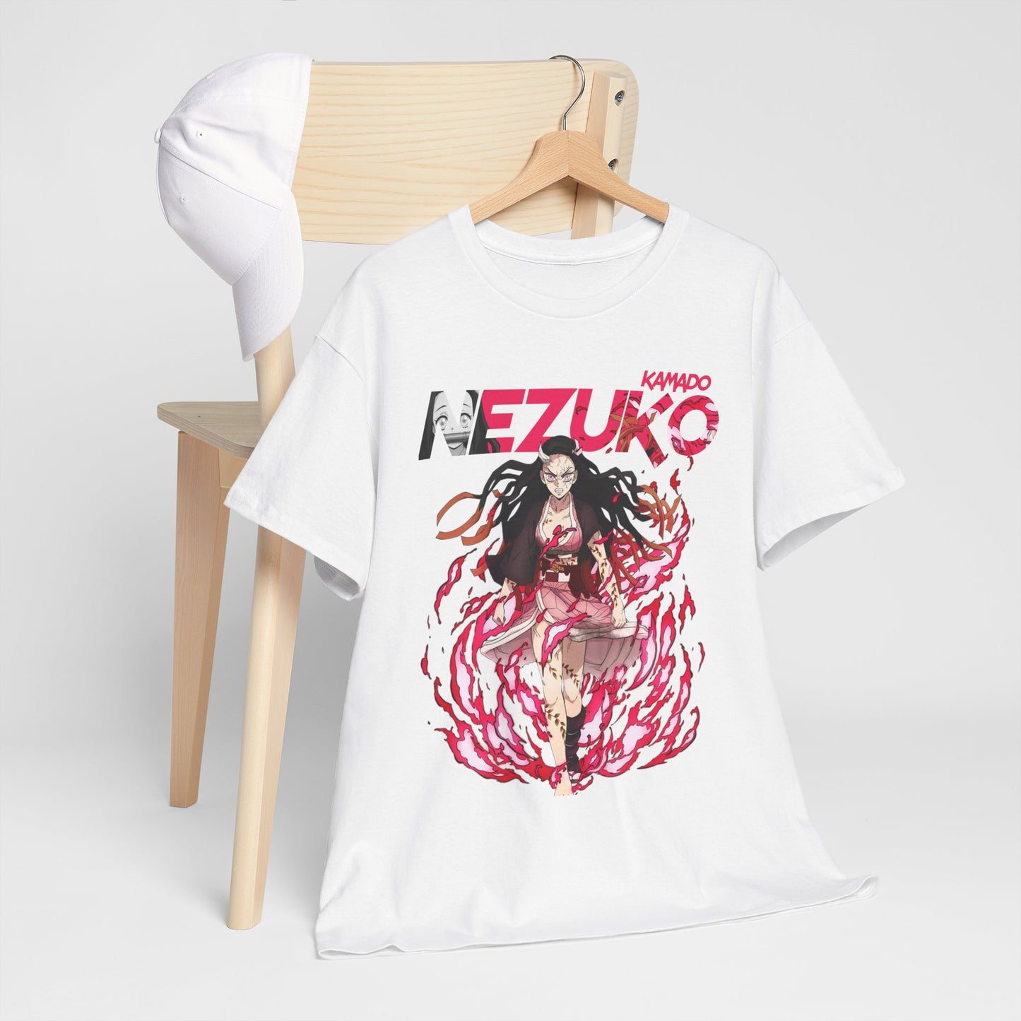 Chic arrangement of a Nezuko Kamado T-shirt paired with a white cap on a wooden chair, exuding a sophisticated anime-inspired lifestyle.