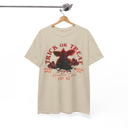Elegant hanging unisex tee showcasing a captivating Demogorgon graphic and 'Trick or Treat' inscription, perfect for fans of supernatural thrillers and stylish apparel.