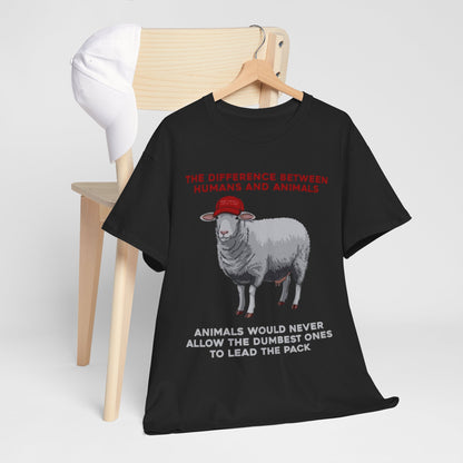 Chic black t-shirt draped over a minimalist chair, featuring a witty sheep illustration with a red cap, enhancing the fashionable statement 'Animals would never allow the dumbest ones to lead the pack'.