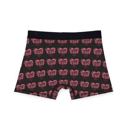 Back view of Valentine's Naughty Cheeky Men's Boxer Briefs showcasing 'I LICKED IT SO IT'S MINE' design in heart graphics on a black background.