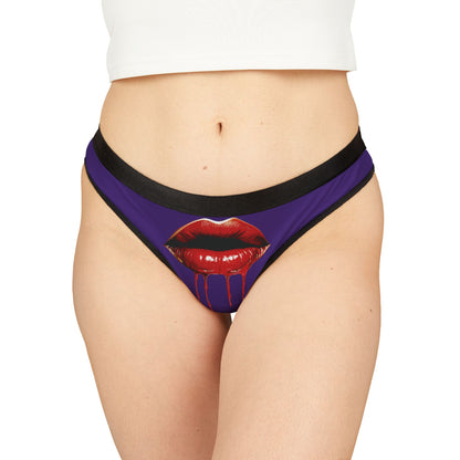 Elegant women's thong featuring a daring graphic of glossy red lips with dripping liquid, set against a rich purple background, combining humour and allure for a romantic occasion.