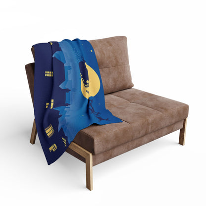 Decorative and Warm Christmas Arctic Fleece Blanket elegantly draped over a modern chair, featuring a festive design with Santa and the moon, perfect for seasonal ambience.