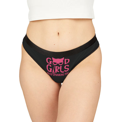 Luxurious black women's thong featuring playful pink graphic, stating 'Good Girls Need Spanking Too', designed for cheeky romance and humour.