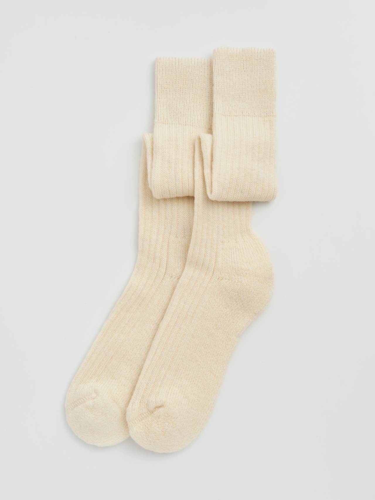 Elegant wool knee high socks showcasing a plush cushioned sole, designed for ultimate comfort and style.