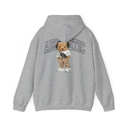 Trendy grey hoodie featuring a cartoon teddy bear with headphones and stylish attire, designed for a unique aesthetic vibe.