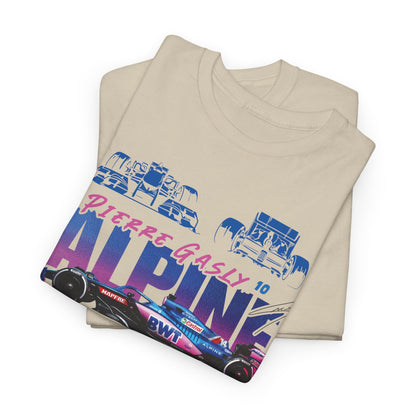 Close-up view of stacked beige Alpine F1 Team men’s t-shirts displaying vibrant graphics and exquisite design details for discerning motorsport fans.