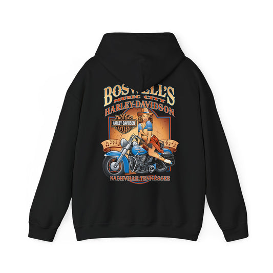 Chic black hoodie showcasing a striking vintage pin-up design of a woman atop a blue motorcycle, complemented by 'Boswell's Music City' and 'Harley-Davidson' logos, ideal for a stylish and adventurous lifestyle.