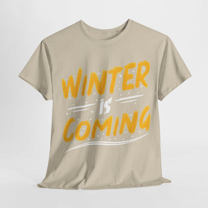 Elegant beige 'Winter Is Coming' Graphic T-Shirt, unisex cotton tee, featuring bold yellow lettering for a stylish winter statement.