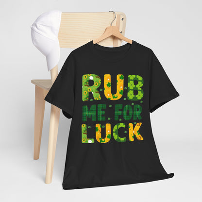 St Patrick's Day unisex graphic cotton t-shirt styled with the phrase 'RUB ME FOR LUCK', displayed elegantly next to a chair, perfect for casual celebrations and gatherings.