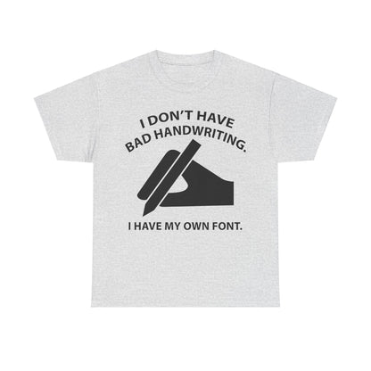 Refined grey graphic unisex t-shirt declaring 'I DON'T HAVE BAD HANDWRITING. I HAVE MY OWN FONT.' featuring a minimalistic hand illustration, a perfect blend of humour and style for the discerning wearer.