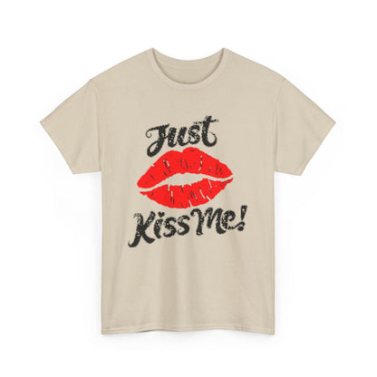Elegant unisex graphic t-shirt featuring a charming design with red lips and the playful phrase 'Just Kiss Me!' on a stylish beige background.