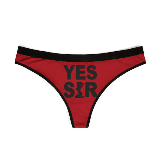 Stylish red women's thong with striking black graphic 'YES SIR', perfect for adding a cheeky touch to luxurious lingerie collections.