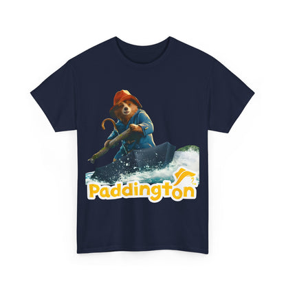 Paddington Bear in Peru Graphic Unisex T-Shirt showcasing Paddington Bear in a charming adventure scene, wearing his iconic blue coat and red hat, navigating on an umbrella-like vessel across whimsical waters, with bold yellow typography stating 'Paddington' beneath.