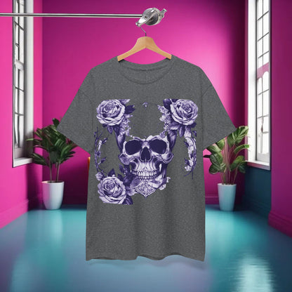 The Skulls and Roses Cotton Tee displayed elegantly on a hanger against a vibrant pink backdrop, showcasing its striking steampunk skull and rose design.