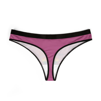 A premium women's thong showing a stylish profile, featuring a captivating pink background and a cheeky message 'Kiss who ever the f*** you want' with a colourful rainbow heart, ideal for romantic occasions.