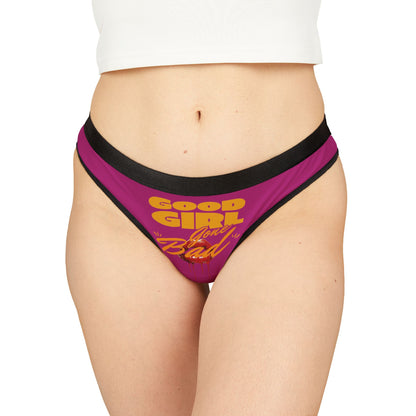 Luxurious women's thong featuring bold typography 'Good Girl Gone Bad' in vibrant yellow and orange on a pink background, styled for a daring and seductive look.
