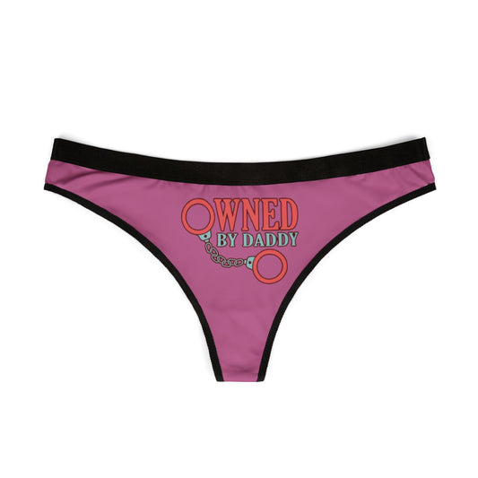 Elegant pink women's thong showcasing 'Owned by Daddy' graphic design, perfect for cheeky gifting and intimate moments.