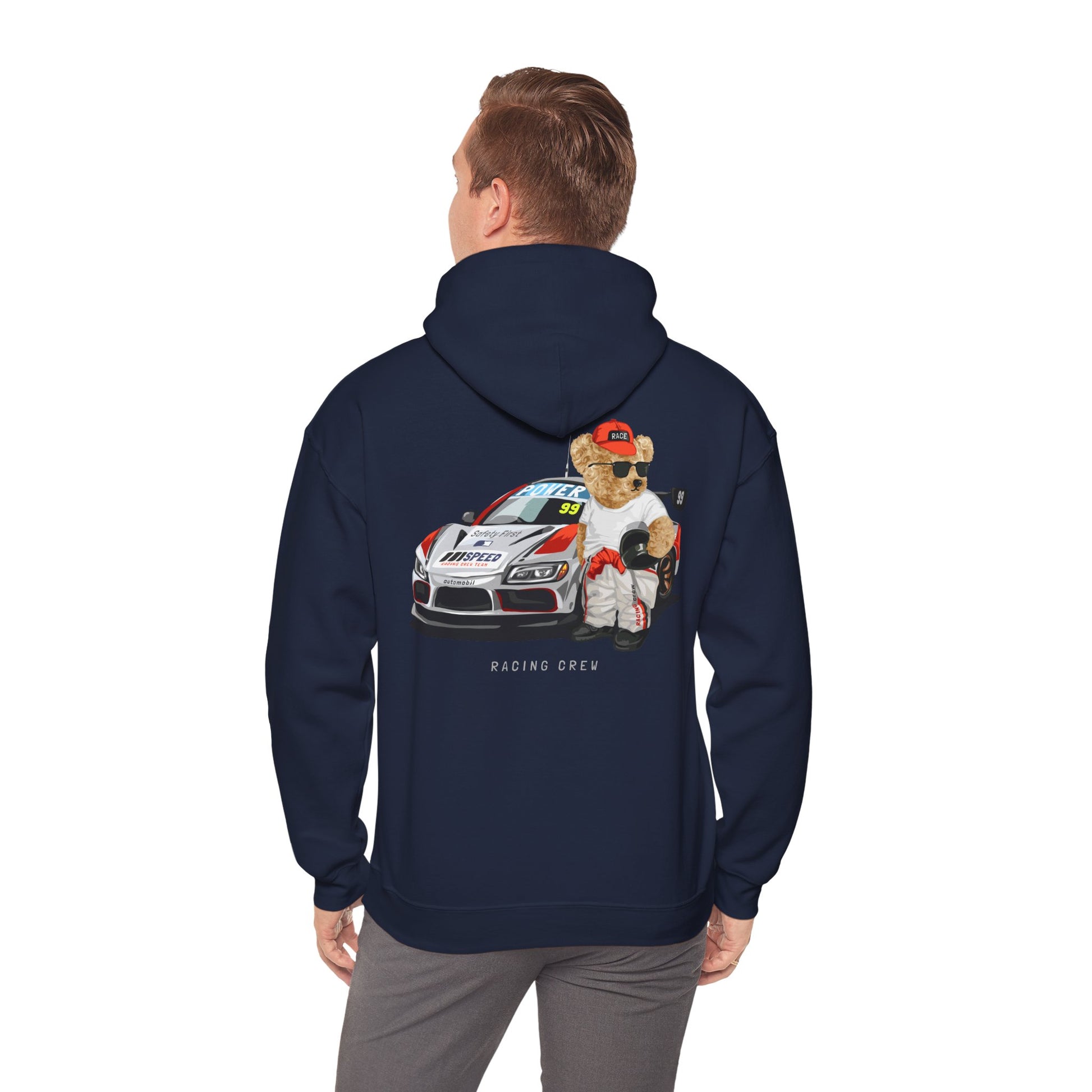 Trendy model showcasing a navy hoodie with an eye-catching teddy bear racer illustration on the back, merging playful design with high-end fashion.