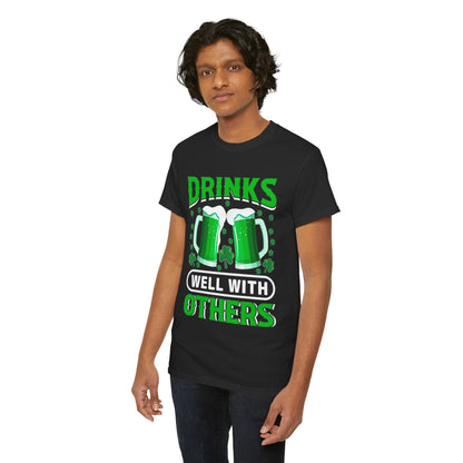 Charming model showcasing a Funny St. Patrick's Day Unisex T-Shirt with green beer mugs and 'Drinks Well With Others', ideal for St. Paddy's festivities.
