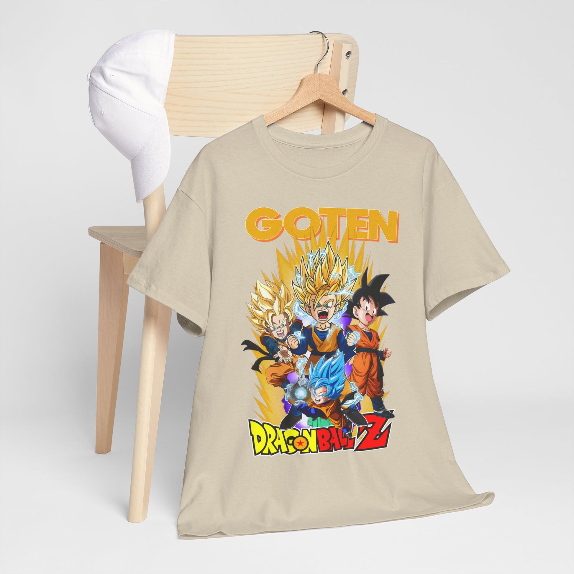 Sophisticated beige Dragon Ball Z T-shirt casually draped over a chair, accented with animated characters and the name GOTEN in bold lettering.