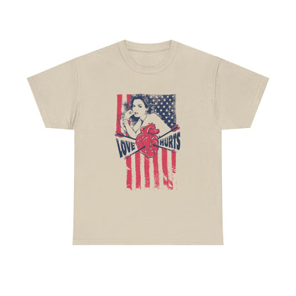 Elegant beige men's t-shirt showcasing a classic pin-up girl graphic on a distressed American flag background, complemented by the phrase 'LOVE HURTS' in deep navy typography, exuding sophistication and a vintage charm.