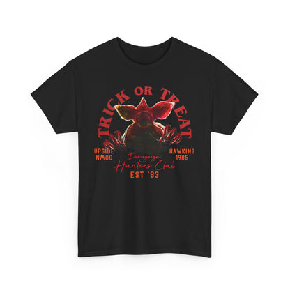 Luxury unisex black graphic t-shirt featuring a Demogorgon design, surrounded by Halloween-themed text including 'TRICK OR TREAT', ideal for fans of 1980s inspired styles.
