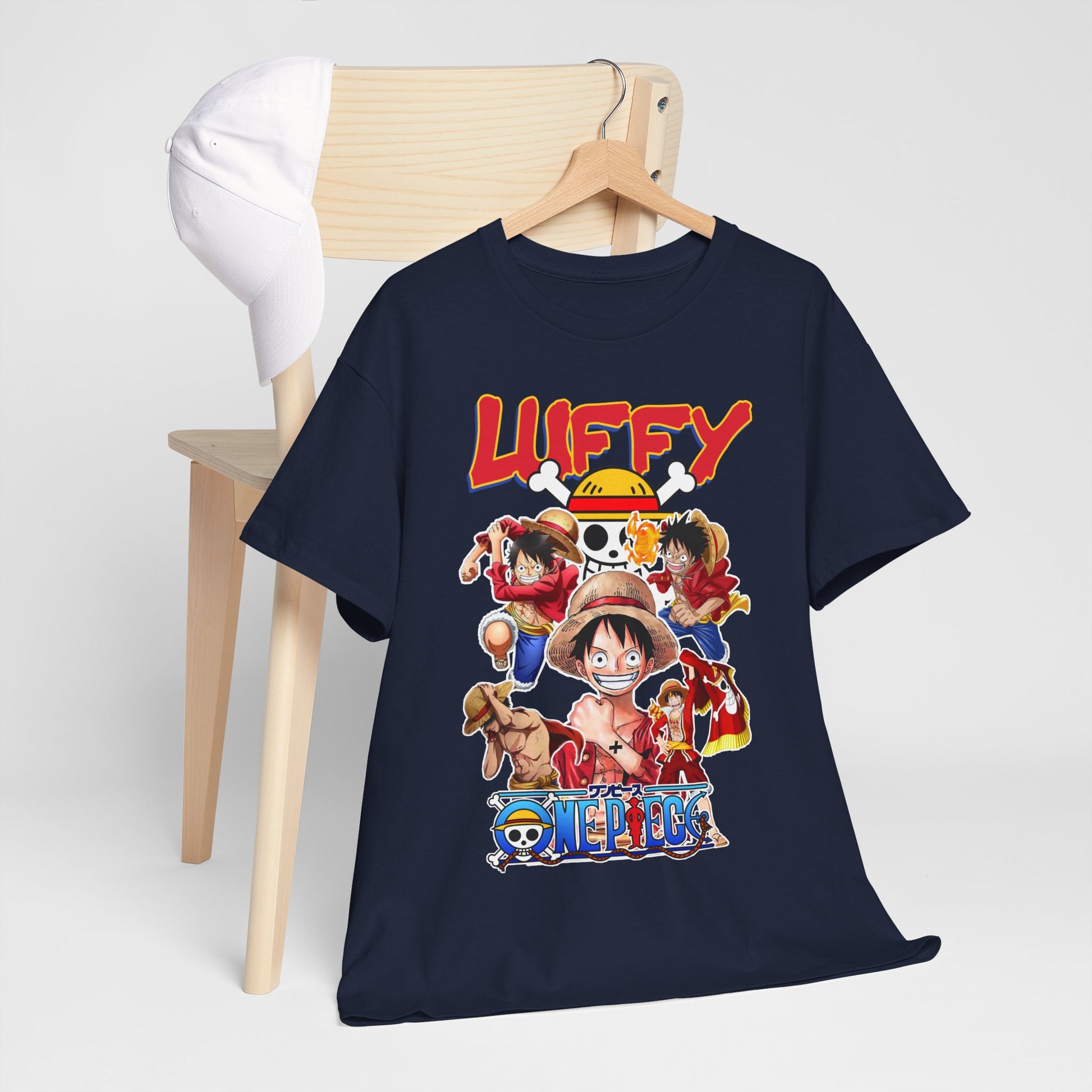Luxury Luffy & Crew graphic T-shirt displayed elegantly on a wooden chair beside a stylish cap, showcasing vibrant anime art behind a minimalistic background.