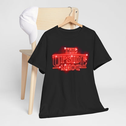 Elegant black graphic cotton t-shirt featuring 'THE UPSIDE DOWN' design in neon-red, styled on a wooden hanger with a white cap, exuding an urban street vibe.